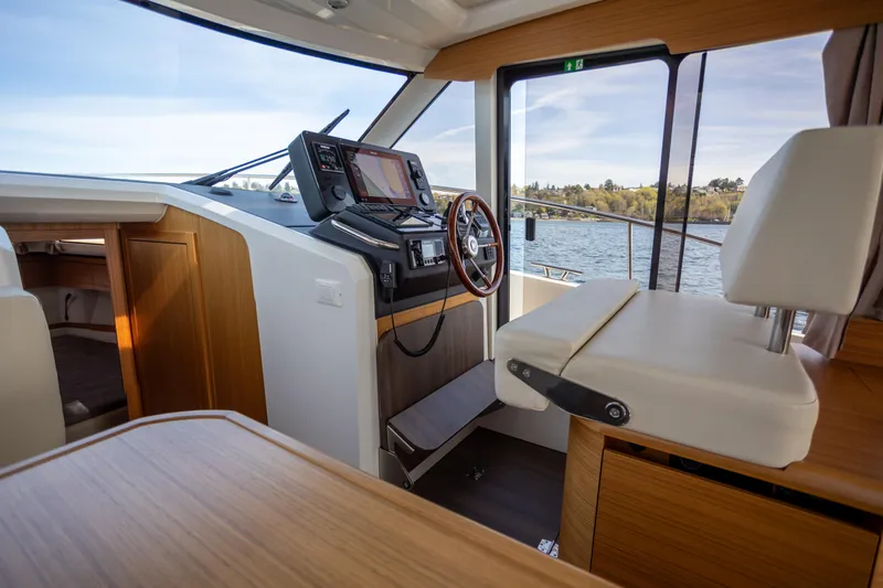 Slide: The Image of Interior of 2024 Greenline 39 yacht with modern helm and wooden accents. - 16