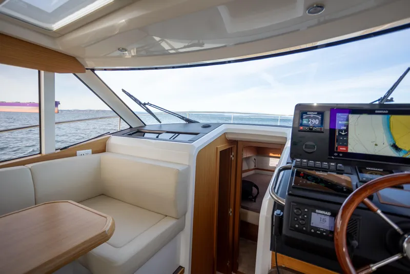 Slide: The Image of Interior of 2024 Greenline 39 yacht with navigation system and seating area. - 19