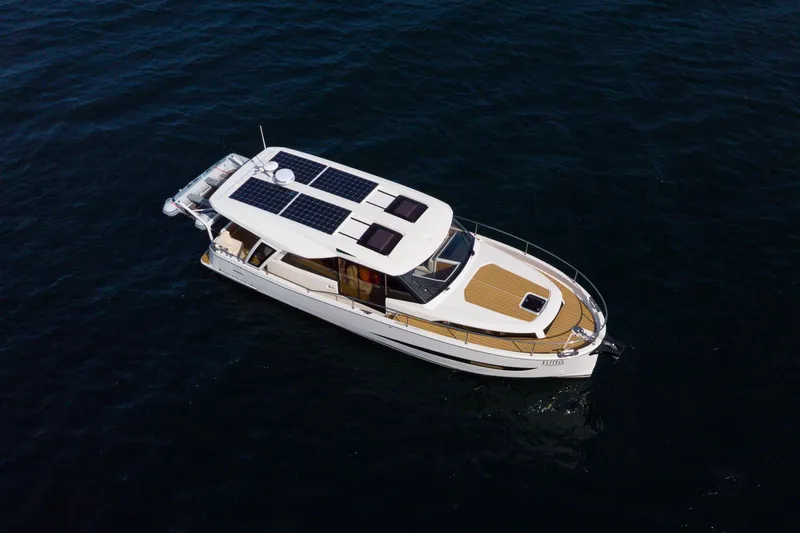 Slide: The Image of 2024 Greenline 39 yacht with solar panels cruising on open water. - 2