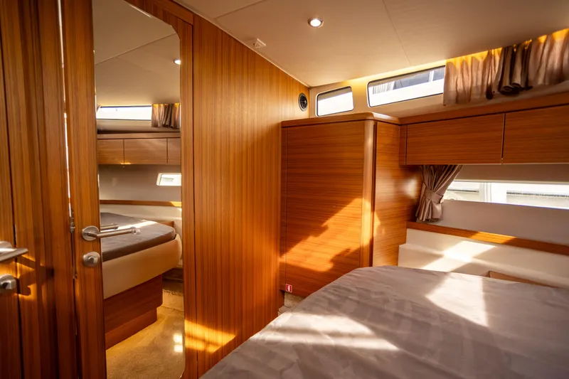 Slide: The Image of Luxurious interior of 2024 Greenline 39 yacht, featuring elegant wood paneling and cozy sleeping quarters. - 20
