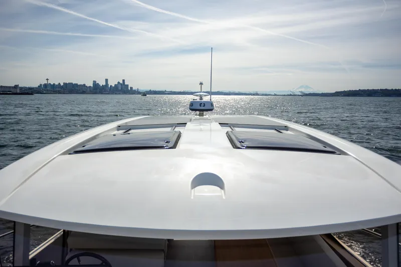 Slide: The Image of 2024 Greenline 39 yacht cruising with city skyline in the background. - 24