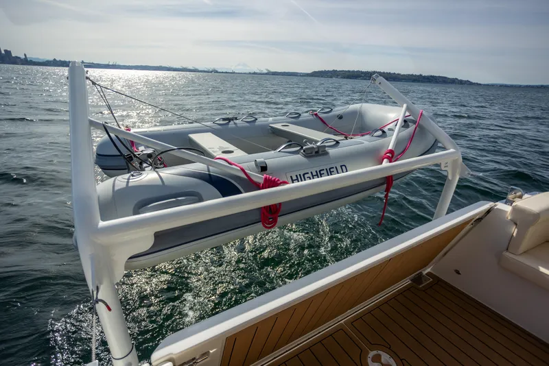 Slide: The Image of 2024 Greenline 39 yacht with Highfield dinghy on davit over water. - 26