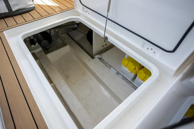 Slide: The Image of Open storage compartment on 2024 Greenline 39 yacht, featuring clean interior and yellow containers. - 29