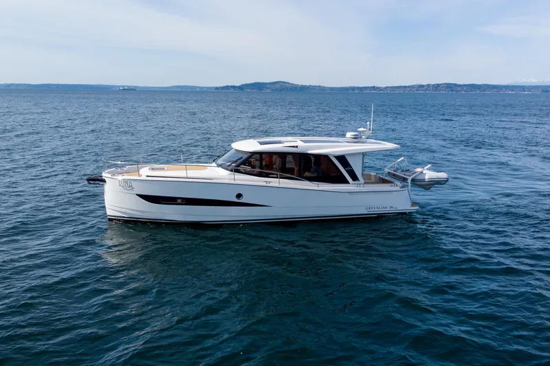Slide: The Image of 2024 Greenline 39 yacht cruising on open water under a clear sky. - 3