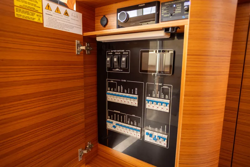 Slide: The Image of Electrical control panel inside 2024 Greenline 39 yacht, featuring switches and circuit breakers. - 31