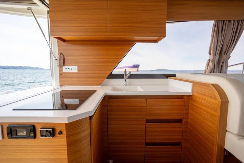 Slide: The Image of Modern kitchen interior on 2024 Greenline 39 yacht with wood finish and ocean view. - 9