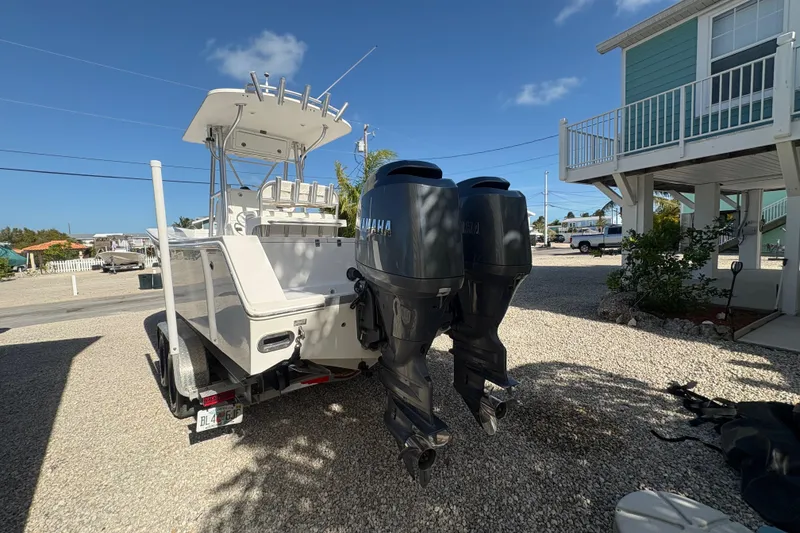 Slide: The Image of 2006 Regulator 24 Classic boat with dual Yamaha engines on a trailer. - 4