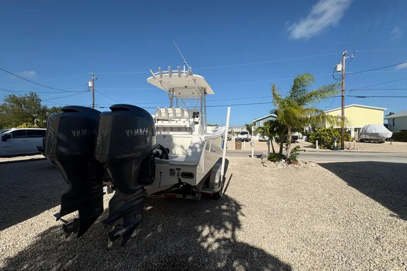 Slide: The Image of 2006 Regulator 24 Classic boat with twin Yamaha engines on a sunny day. - 5