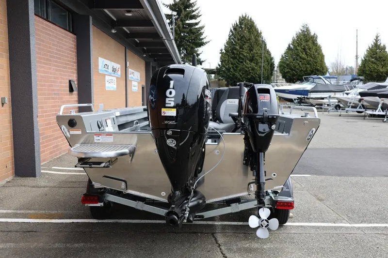 Slide: The Image of 2026 Thunder Jet 209 Rush OT boat with dual outboard motors in a marina setting. - 11