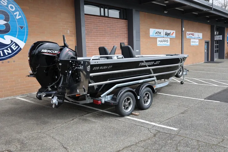 Slide: The Image of 2026 Thunder Jet 209 Rush OT boat with Mercury engine in parking lot. - 14