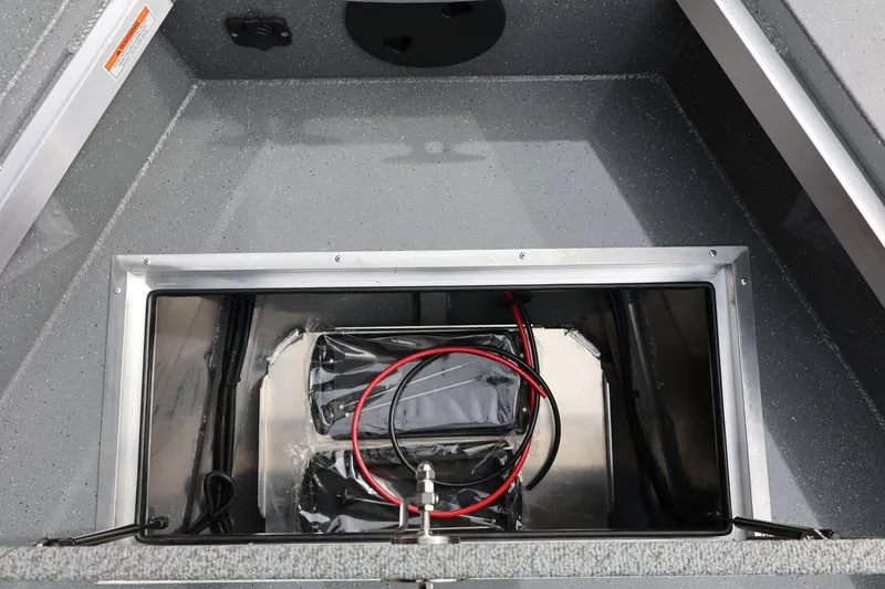Slide: The Image of 2026 Thunder Jet 209 Rush OT boat battery compartment with wiring and storage space. - 22