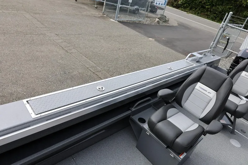 Slide: The Image of 2026 Thunder Jet 209 Rush OT boat interior with sleek seating and storage compartment. - 24