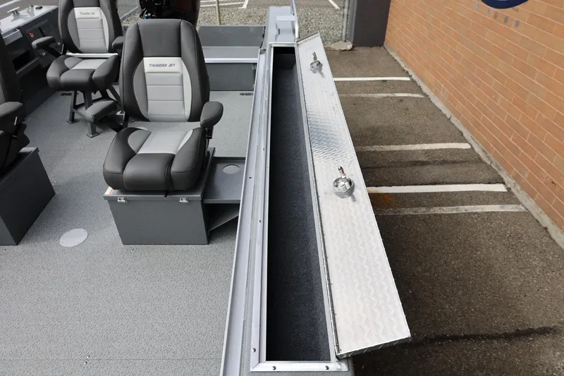 Slide: The Image of 2026 Thunder Jet 209 Rush OT boat interior with seating and storage compartment. - 27