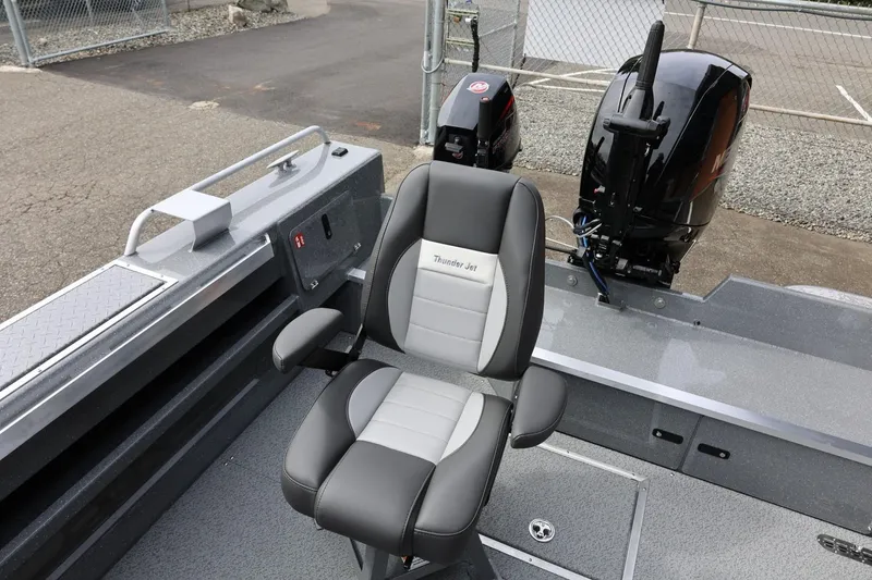 Slide: The Image of 2026 Thunder Jet 209 Rush OT boat interior with captain's chair and motor. - 31