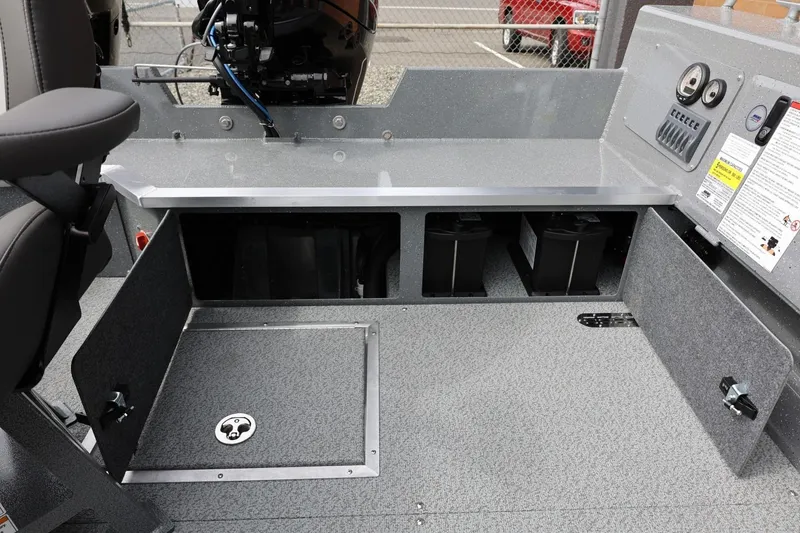 Slide: The Image of 2026 Thunder Jet 209 Rush OT boat interior with open storage compartments and control panel. - 34