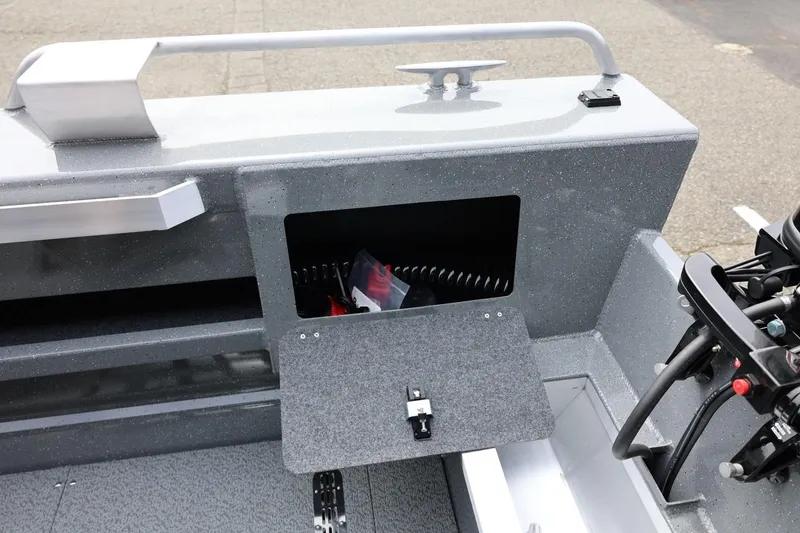 Slide: The Image of 2026 Thunder Jet 209 Rush OT boat interior with open storage compartment and control panel. - 37