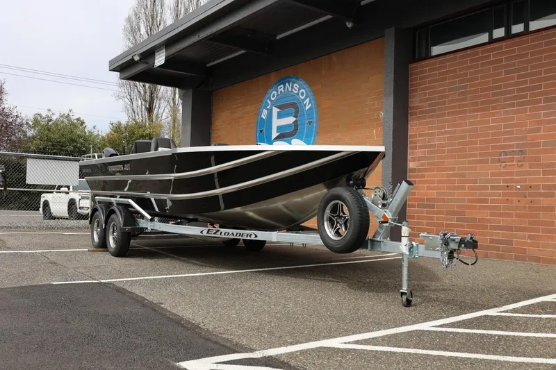 Slide: The Image of 2026 Thunder Jet 209 Rush OT boat on trailer outside a building. - 4