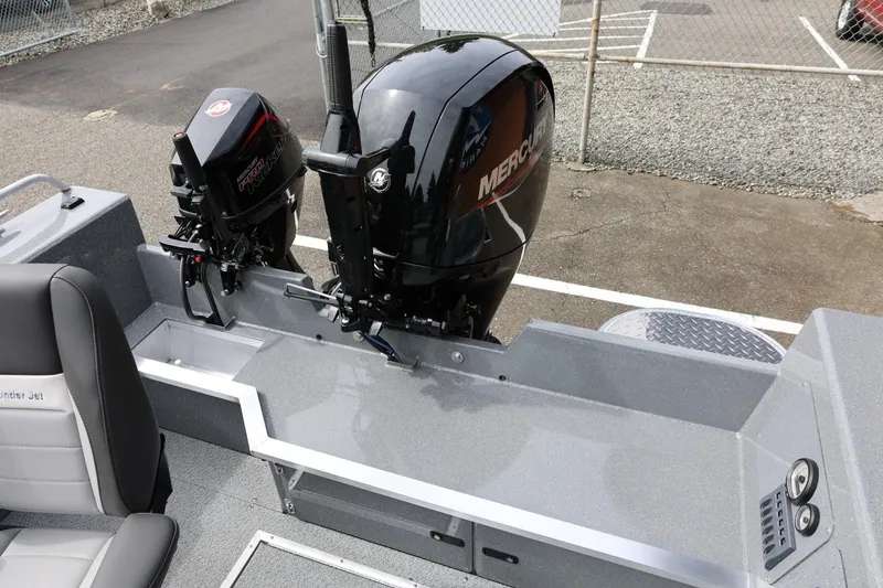 Slide: The Image of 2026 Thunder Jet 209 Rush OT boat with dual Mercury outboard motors, parked on concrete. - 40