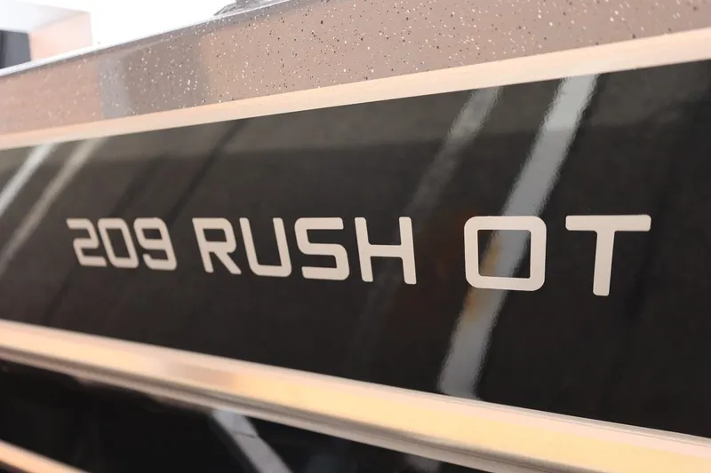 Slide: The Image of 2026 Thunder Jet 209 Rush OT boat model nameplate in close-up view. - 44