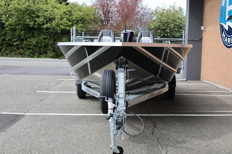 Slide: The Image of 2026 Thunder Jet 209 Rush OT boat on trailer in parking lot. - 5