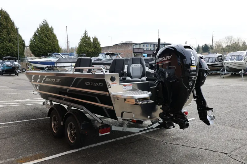 Slide: The Image of 2026 Thunder Jet 209 Rush OT boat with Mercury outboard motor in a marina. - 9