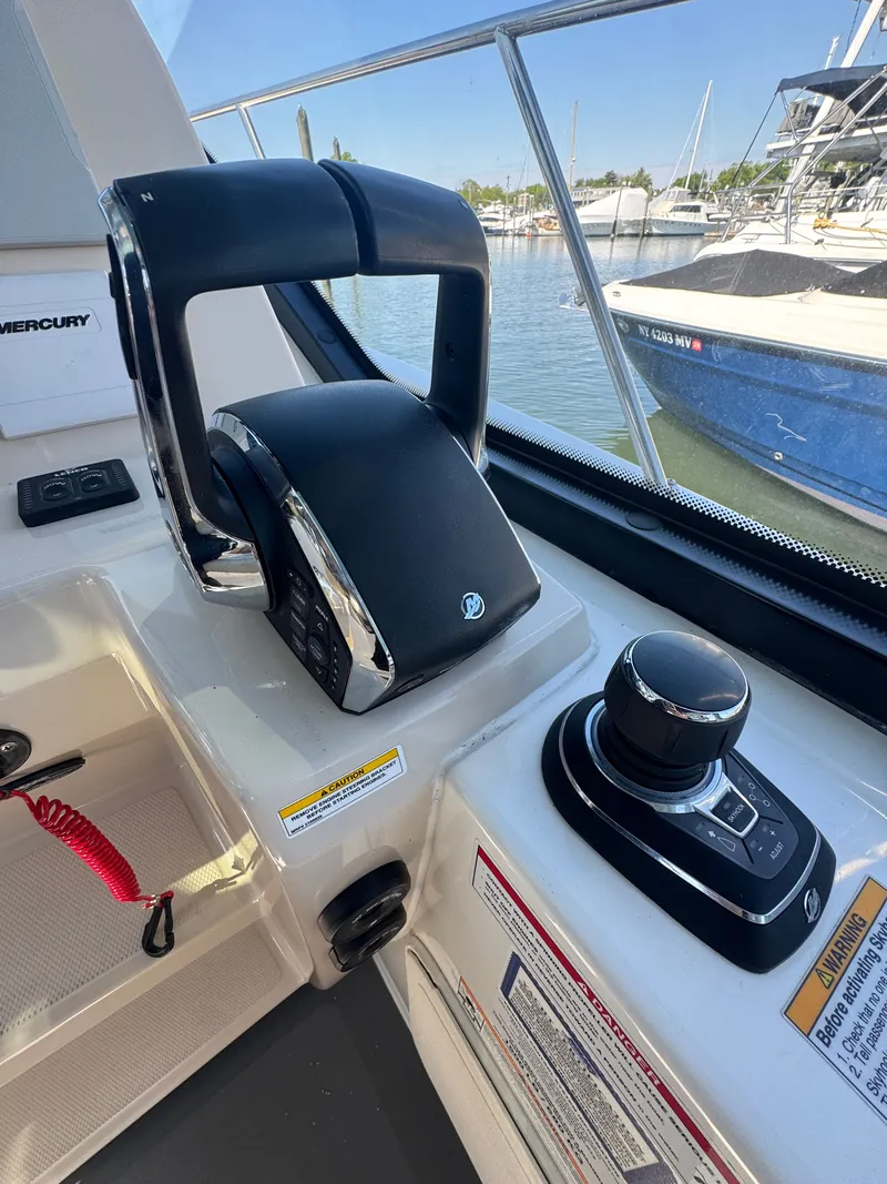 Slide: The Image of Interior of 2024 Boston Whaler 325 Conquest with luxurious captain's chair. - 10