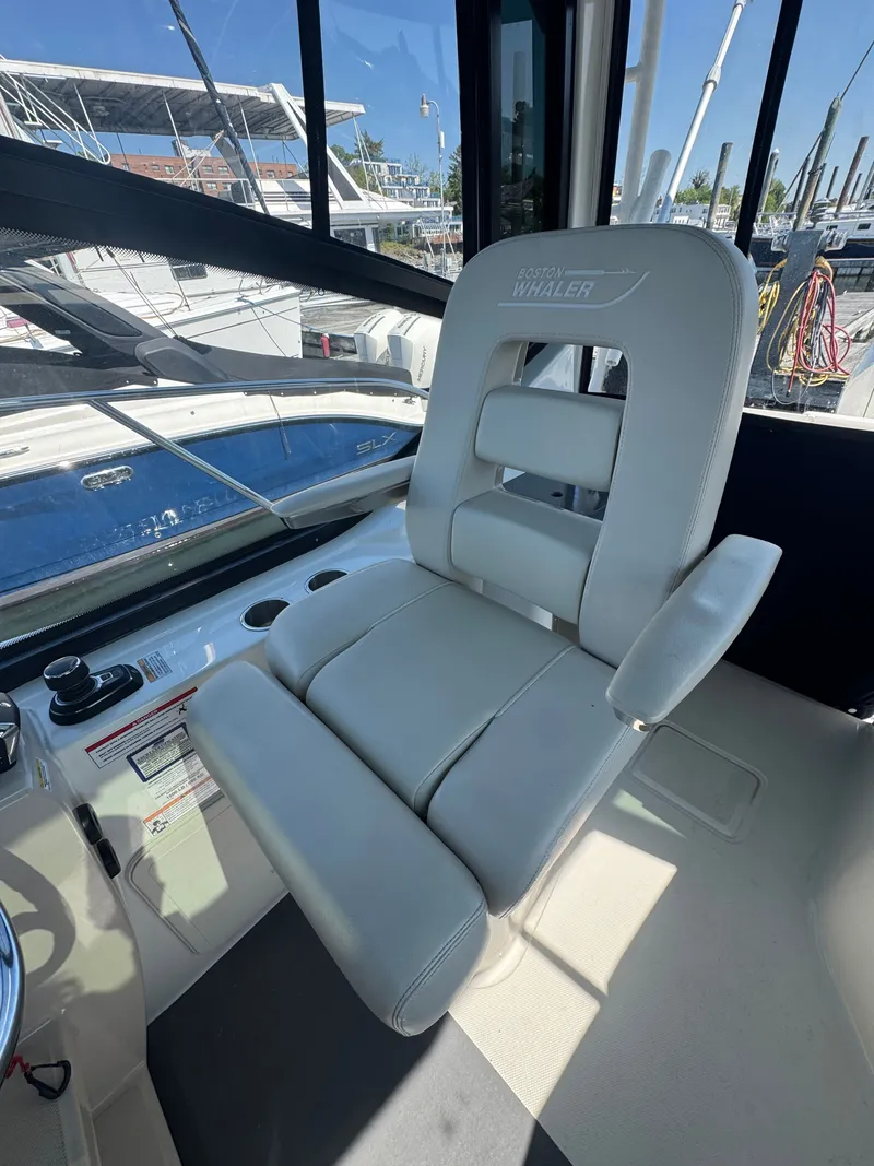 Slide: The Image of Boston Whaler 325 Conquest 2024 with built-in grill on deck. - 12