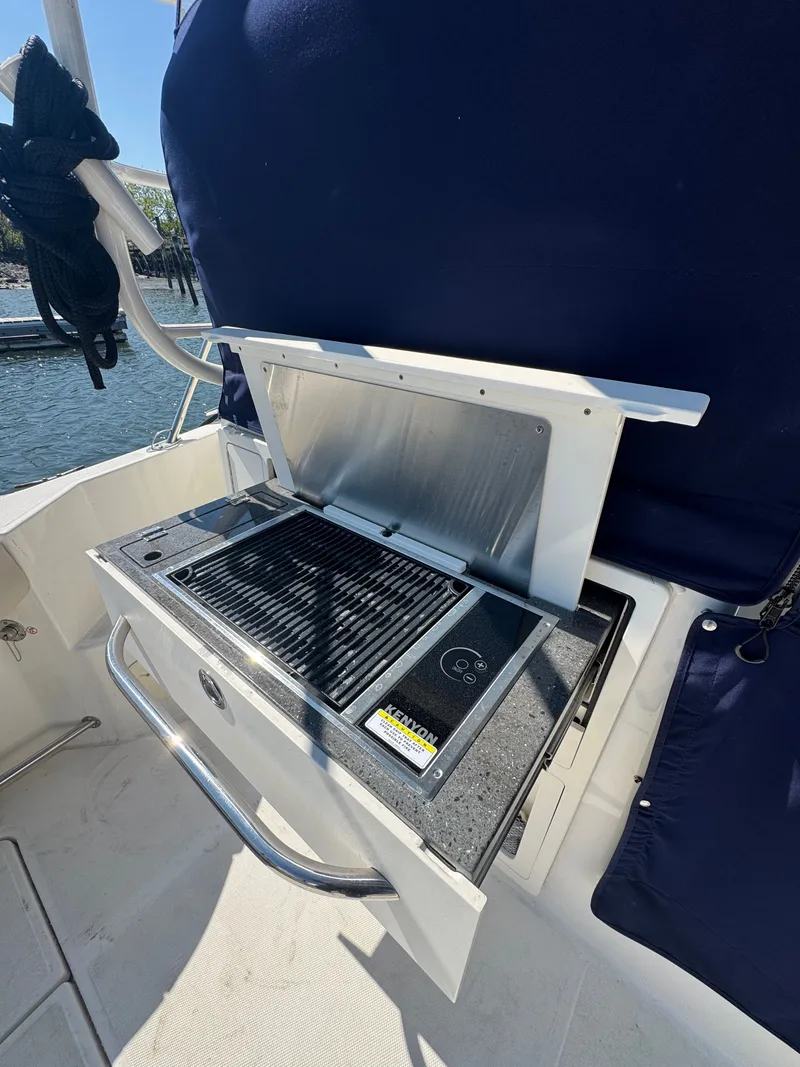 Slide: The Image of Boston Whaler 325 Conquest 2024 at dock with twin outboard engines. - 14