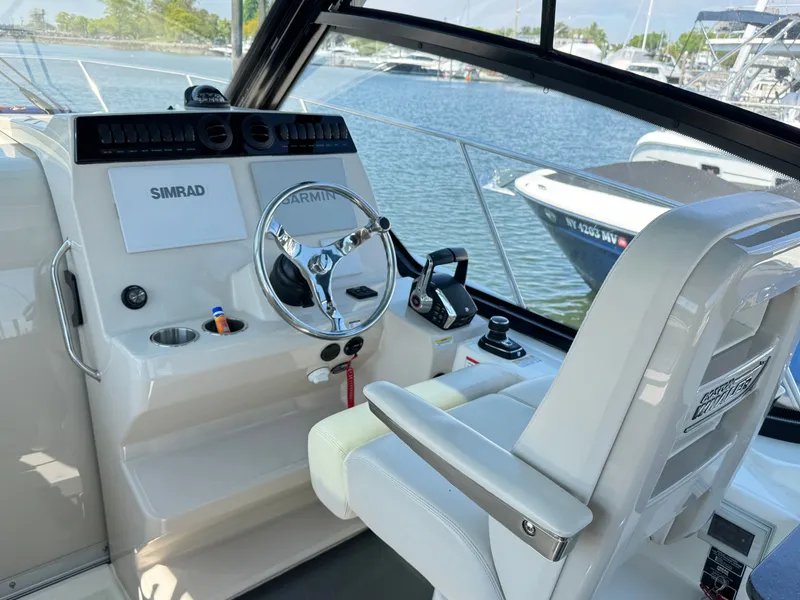 Slide: The Image of Interior of 2024 Boston Whaler 325 Conquest with seating area and table. - 16