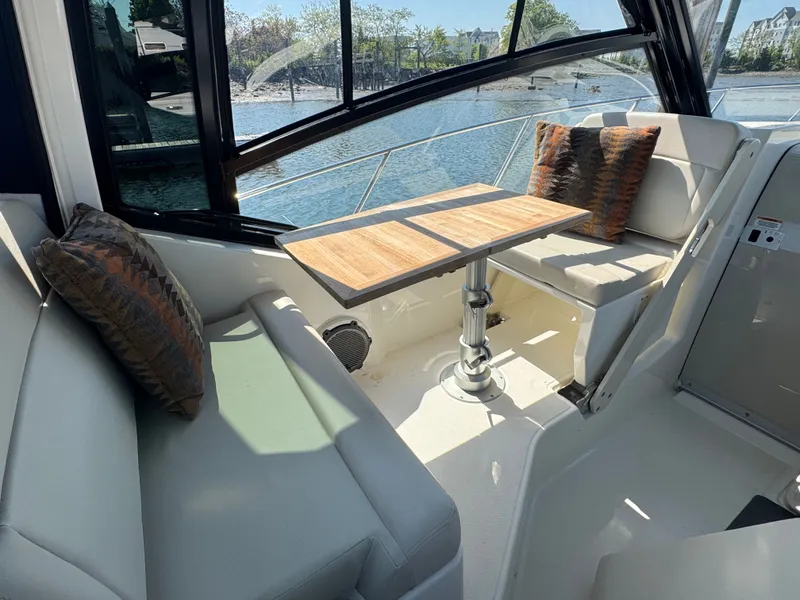 Slide: The Image of Interior of 2024 Boston Whaler 325 Conquest with seating and table. - 17