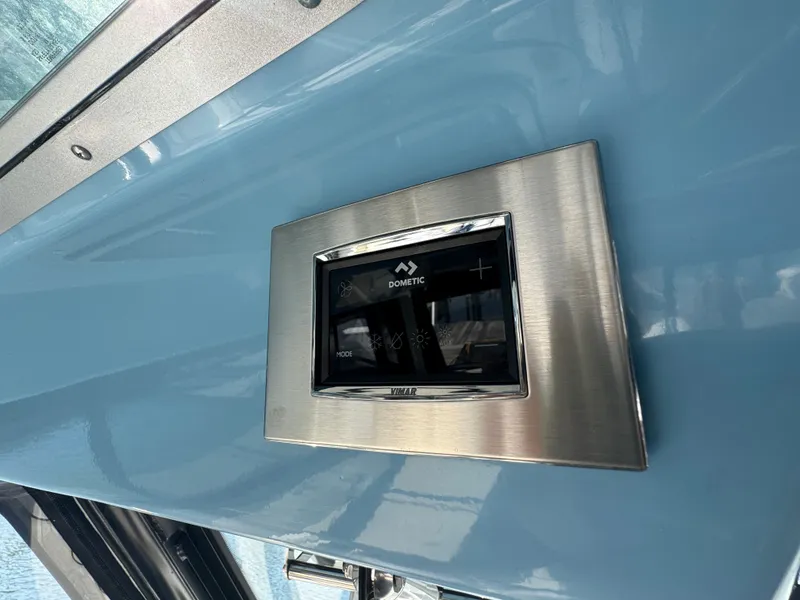 Slide: The Image of 2024 Boston Whaler 325 Conquest control panel in stainless steel frame. - 19
