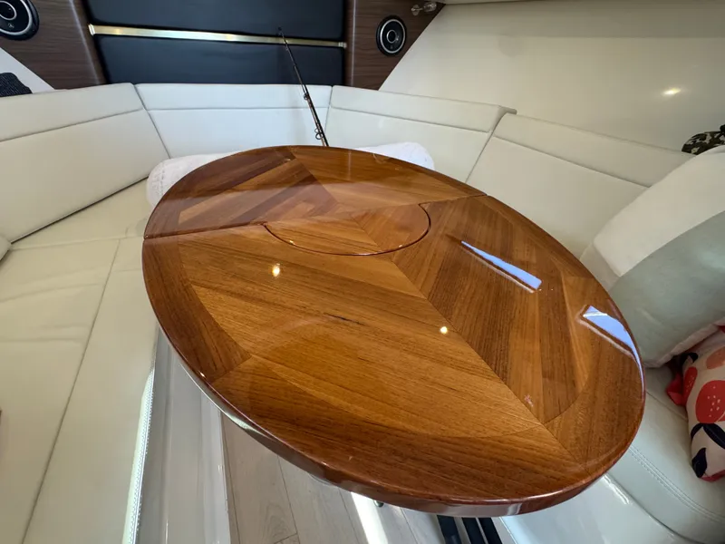 Slide: The Image of Luxurious wooden table in the interior of the 2024 Boston Whaler 325 Conquest. - 21