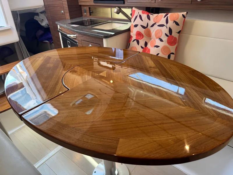 Slide: The Image of Interior of 2024 Boston Whaler 325 Conquest with kitchen and seating area. - 24