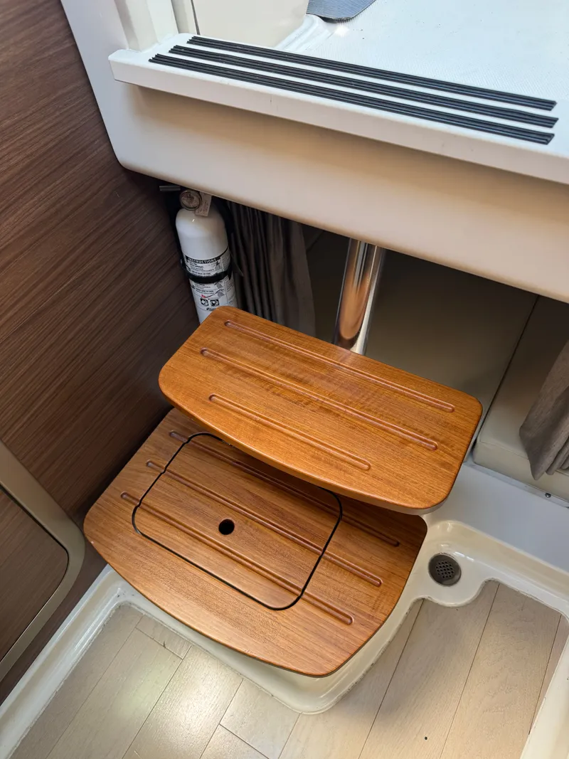 Slide: The Image of Interior of 2024 Boston Whaler 325 Conquest with toilet and sink. - 27