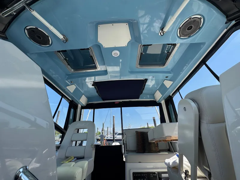 Slide: The Image of Interior of 2024 Boston Whaler 325 Conquest with blue ceiling. - 29