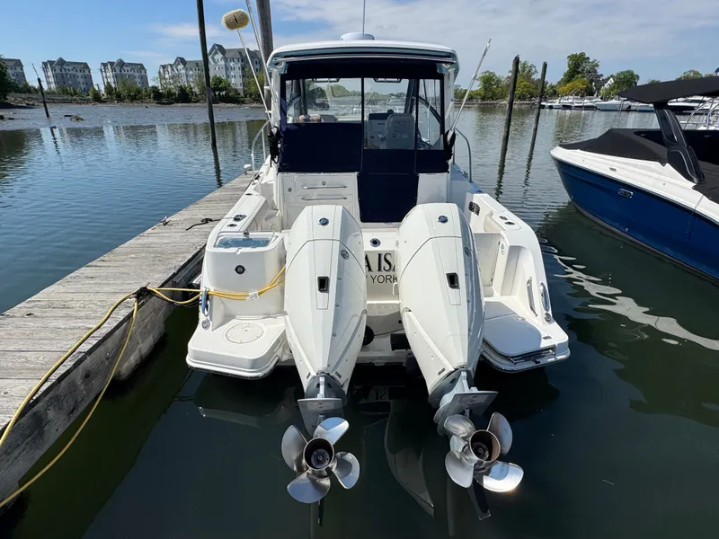 Slide: The Image of 2024 Boston Whaler 325 Conquest docked with dual engines. - 3