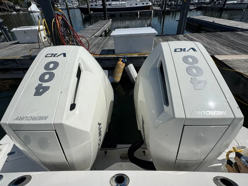 Slide: The Image of 2024 Boston Whaler 325 Conquest with foldable seats at the marina. - 30