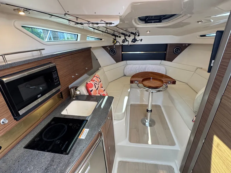Slide: The Image of Interior view of 2024 Boston Whaler 325 Conquest boat with blue ceiling. - 37