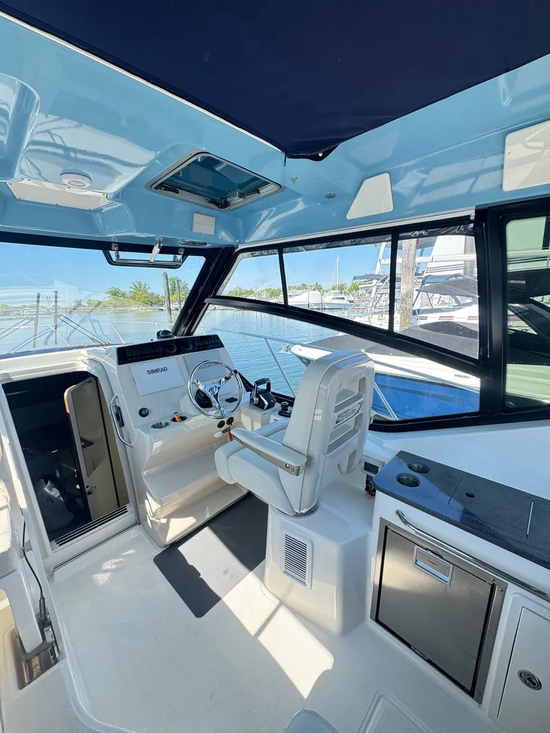 Slide: The Image of 2024 Boston Whaler 325 Conquest helm with joystick control. - 7