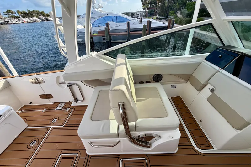 Slide: The Image of 2022 Boston Whaler 280 Vantage interior with luxurious seating and teak flooring. - 10