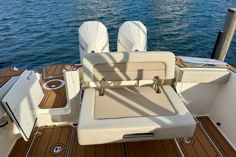 Slide: The Image of 2022 Boston Whaler 280 Vantage boat with dual Mercury engines and cushioned seating. - 12
