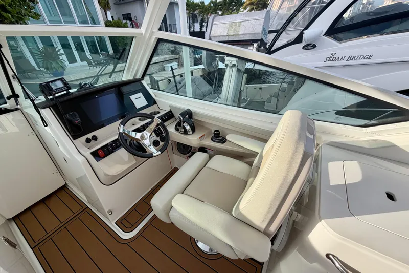 Slide: The Image of Helm of 2022 Boston Whaler 280 Vantage with modern controls and comfortable seating. - 14