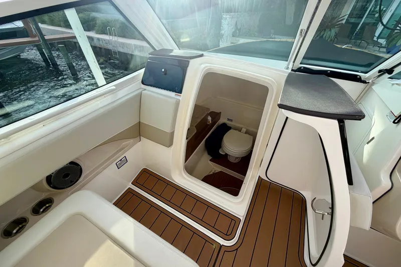Slide: The Image of 2022 Boston Whaler 280 Vantage boat interior with cabin and toilet, featuring sleek design. - 15