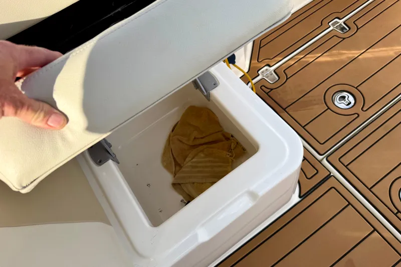 Slide: The Image of 2022 Boston Whaler 280 Vantage seat storage compartment with teak-style flooring. - 20