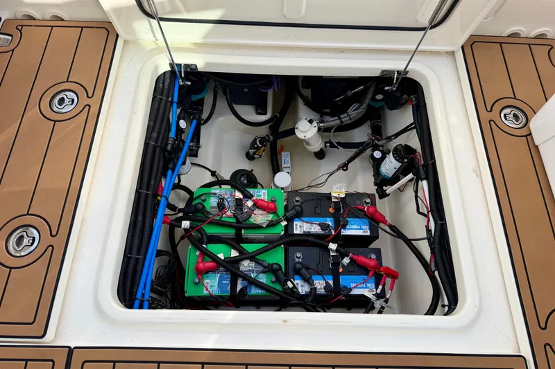 Slide: The Image of Battery compartment of a 2022 Boston Whaler 280 Vantage boat, showcasing wiring and components. - 25