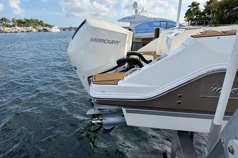 Slide: The Image of 2022 Boston Whaler 280 Vantage with Mercury outboard engine docked by the water. - 5