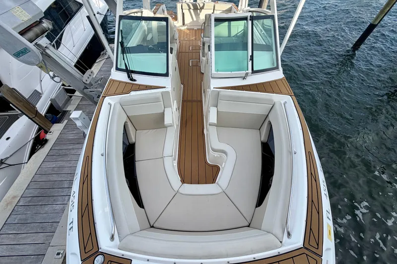Slide: The Image of 2022 Boston Whaler 280 Vantage boat with spacious seating and elegant design docked by the water. - 7