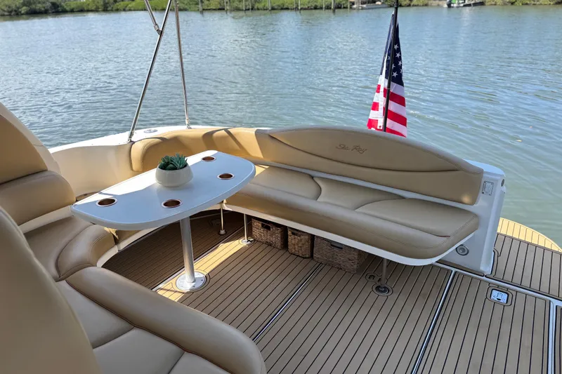 Slide: The Image of Luxurious 2002 Sea Ray 380 Sundancer boat interior with seating and table on calm water. - 11