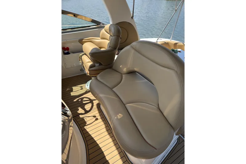 Slide: The Image of Luxurious seating on 2002 Sea Ray 380 Sundancer yacht, featuring tan leather upholstery. - 14