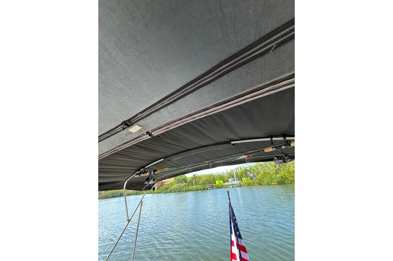 Slide: The Image of View from a 2002 Sea Ray 380 Sundancer boat, featuring a canopy and waterway. - 18